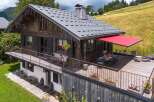 This charming chalet-style home offers a perfect blend of rustic charm and modern comfort.