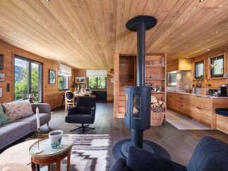 Experience the warmth of this stunning chalet, featuring exquisite wooden interiors and a cozy fireplace.