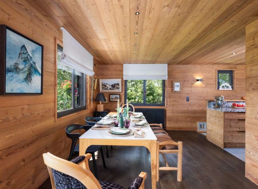 This stunning dining room showcases a warm and inviting atmosphere with its beautiful wooden walls and ceiling.