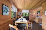 This stunning dining room showcases a warm and inviting atmosphere with its beautiful wooden walls and ceiling.