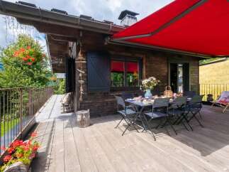 Enjoy the tranquility of this charming wooden cabin with a spacious deck, perfect for outdoor dining and relaxation.