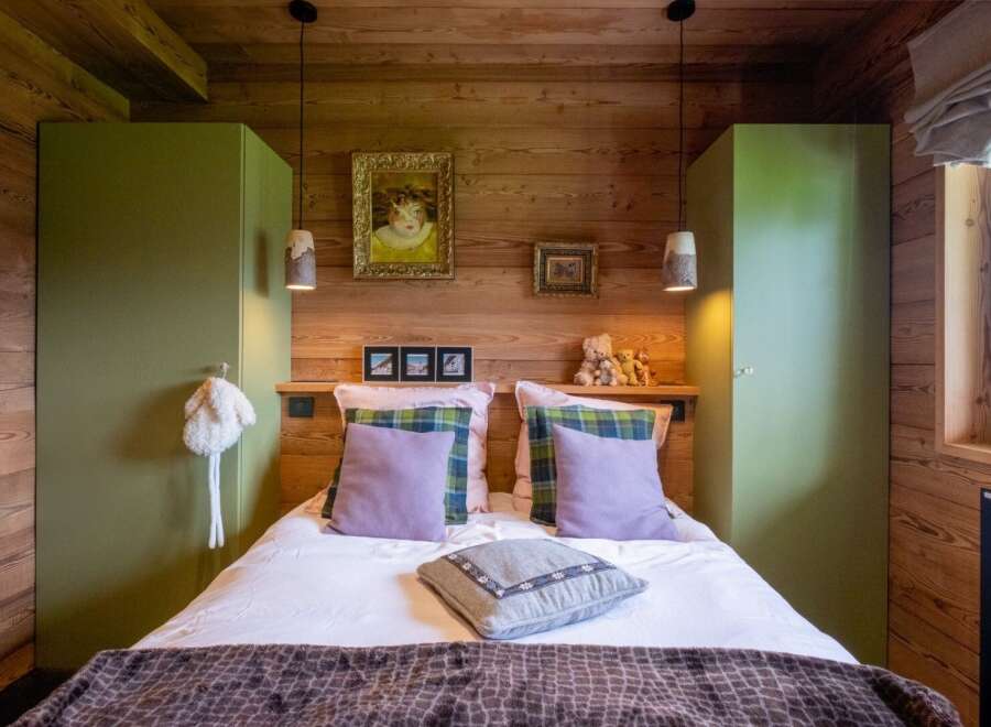 This cozy bedroom features a rustic wooden design, creating a warm and inviting atmosphere.