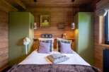 This cozy bedroom features a rustic wooden design, creating a warm and inviting atmosphere.