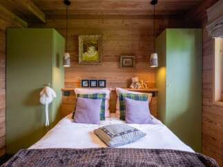 This cozy bedroom features a rustic wooden design, creating a warm and inviting atmosphere.