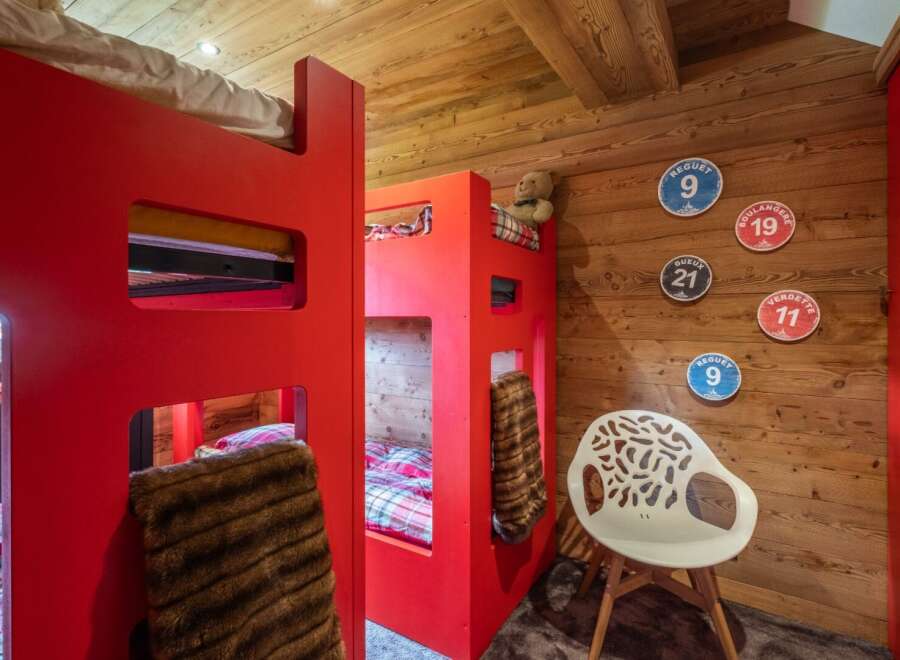 This charming bedroom features a unique bunk bed design, perfect for a cozy and stylish living space.