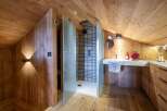This stunning bathroom boasts a unique design with wooden walls and ceiling, creating a warm and inviting atmosphere.