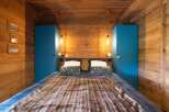 This cozy bedroom features a rustic wooden design with a warm and inviting atmosphere.