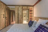 This stunning bedroom showcases a blend of rustic charm and modern design.