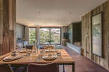Experience luxury living in this stunning property, featuring a beautifully set dining table perfect for hosting.