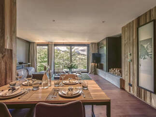 Experience luxury living in this stunning property, featuring a beautifully set dining table perfect for hosting.