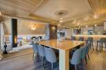 Experience luxury living in this stunning property featuring a modern dining area with a sleek wooden table and stylish chairs.