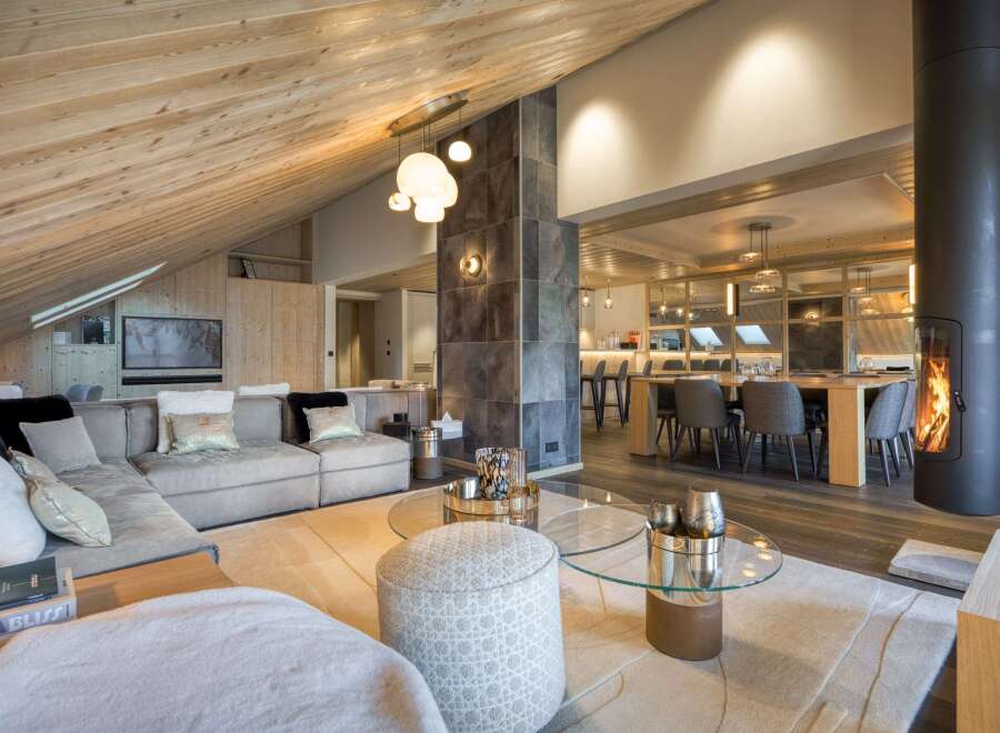 Experience luxury living in this stunning property, featuring a spacious living area with a cozy fireplace and a modern open-plan design.