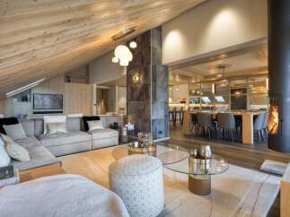 Experience luxury living in this stunning property, featuring a spacious living area with a cozy fireplace and a modern open-plan design.