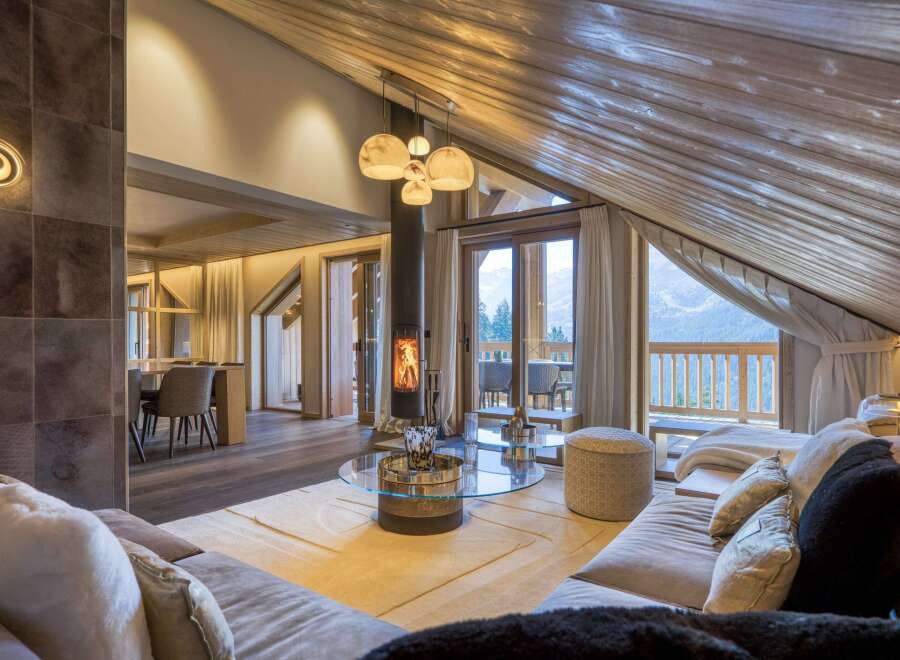Experience luxury living in this stunning chalet, featuring a cozy fireplace and breathtaking mountain views.