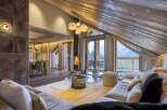 Experience luxury living in this stunning chalet, featuring a cozy fireplace and breathtaking mountain views.