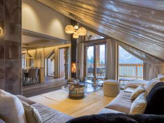 Experience luxury living in this stunning chalet, featuring a cozy fireplace and breathtaking mountain views.
