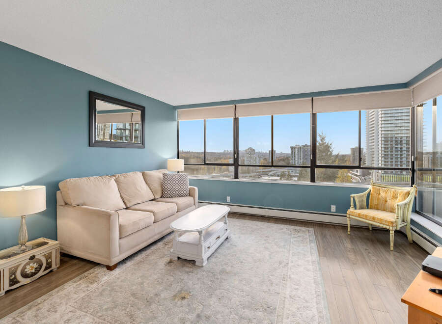 This stunning condo boasts breathtaking city views from expansive windows, creating a bright and inviting living space.