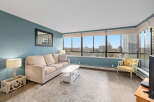 This stunning condo boasts breathtaking city views from expansive windows, creating a bright and inviting living space.