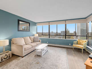 This stunning condo boasts breathtaking city views from expansive windows, creating a bright and inviting living space.
