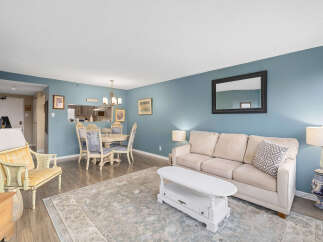 Step into this inviting living space, featuring a cozy sofa and a stylish coffee table, perfect for relaxation and entertaining.