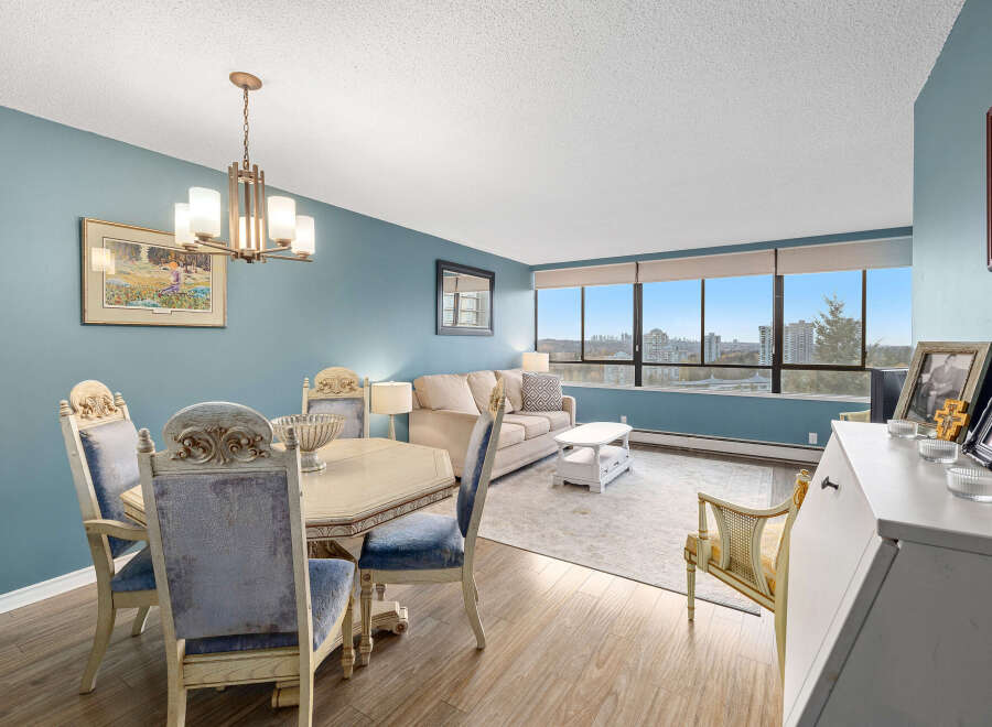 This stunning property boasts a spacious living area with a beautiful dining set, perfect for entertaining.