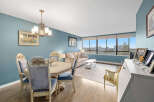 This stunning property boasts a spacious living area with a beautiful dining set, perfect for entertaining.
