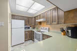 This charming kitchen boasts ample cabinet space and a functional layout, perfect for culinary enthusiasts.