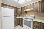This charming kitchen features beautiful wooden cabinetry, offering ample storage and a warm, inviting atmosphere.