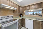 This kitchen features a modern design with ample cabinet space and a sleek countertop.