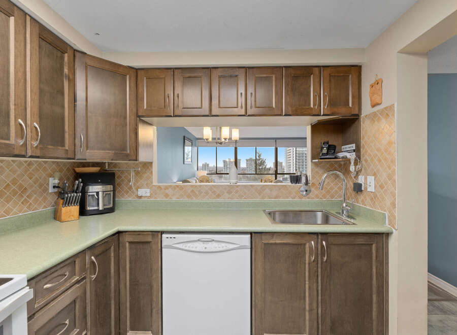 This kitchen features beautiful wooden cabinets and a modern design.