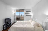 This bright and airy bedroom offers stunning views and a comfortable living space.