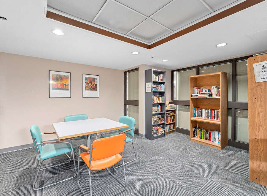Discover a cozy reading nook in this inviting space! This room features a table and chairs, perfect for enjoying a good book.
