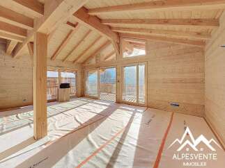 Discover the charm of this stunning property, featuring a spacious interior with exposed wooden beams and walls, creating a warm and inviting atmosphere.