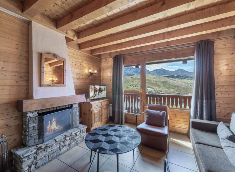 Experience the charm of this cozy chalet, featuring a stone fireplace and wooden accents throughout.