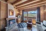 Experience the charm of this cozy chalet, featuring a stone fireplace and wooden accents throughout.