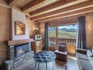 Experience the charm of this cozy chalet, featuring a stone fireplace and wooden accents throughout.