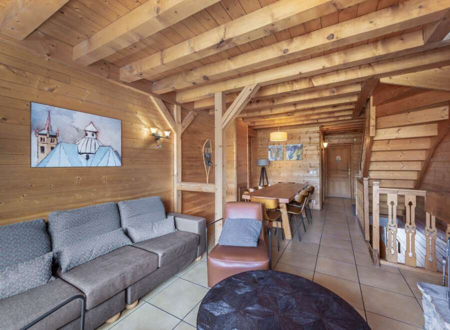 Step into this cozy chalet, featuring stunning wood paneling and exposed beams that create a warm and inviting atmosphere.