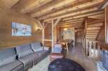 Step into this cozy chalet, featuring stunning wood paneling and exposed beams that create a warm and inviting atmosphere.