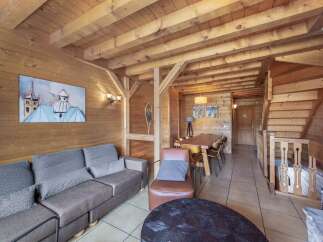 Step into this cozy chalet, featuring stunning wood paneling and exposed beams that create a warm and inviting atmosphere.