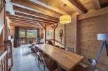 Experience the charm of this stunning property, featuring a spacious dining area with a large wooden table, perfect for gatherings.