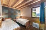 This cozy bedroom features two twin beds with crisp white linens, perfect for a comfortable stay.