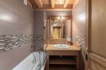 Step into this beautifully designed bathroom, featuring a stylish combination of wood and tile.