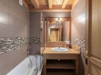 Step into this beautifully designed bathroom, featuring a stylish combination of wood and tile.