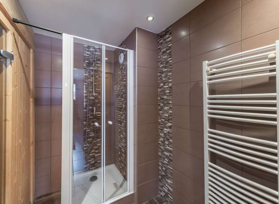 Step into a modern bathroom oasis! This stunning space features a sleek glass shower enclosure, perfect for a refreshing start to your day.