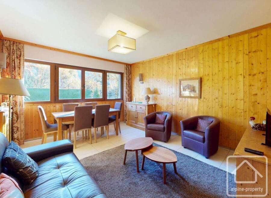 This charming property boasts a cozy living space with a dining area, perfect for entertaining.