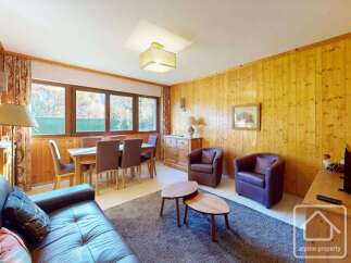 This charming property boasts a cozy living space with a dining area, perfect for entertaining.