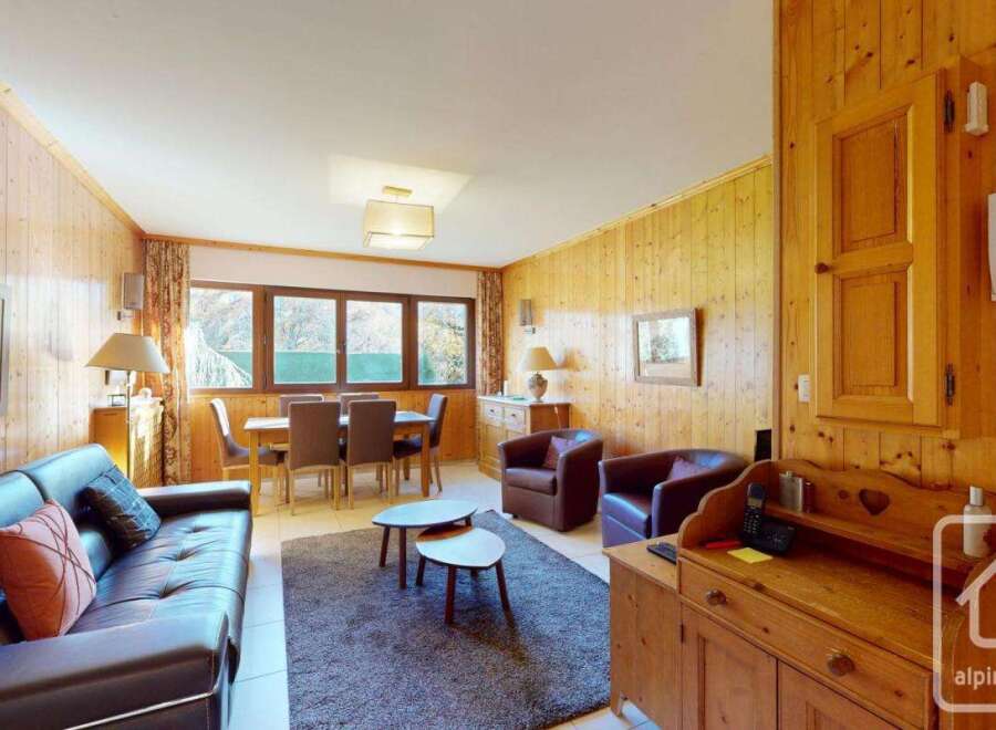 Discover the charm of this inviting property, featuring a cozy living space with a comfortable leather sofa and a dining area perfect for gatherings.