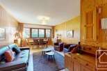 Discover the charm of this inviting property, featuring a cozy living space with a comfortable leather sofa and a dining area perfect for gatherings.