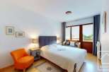 This cozy bedroom features a comfortable bed with a stylish headboard, perfect for a relaxing retreat.