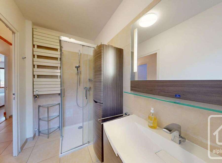 This modern bathroom features a sleek design with a glass shower enclosure and a stylish vanity.